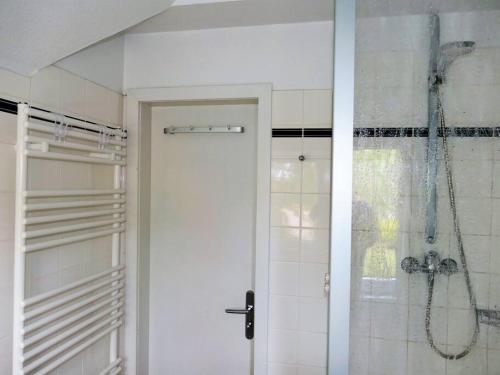 a bathroom with a shower and a glass door at Ferienwohnung: Utkiek in Langeoog