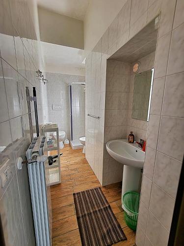 a small bathroom with a sink and a toilet at B&B Duca Orsini in Gravina in Puglia