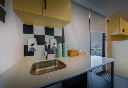 a kitchen with a sink and a counter top at Go Camp Mountain Nature Lodge مخيم الطبيعة الجبلية in Sharīyah