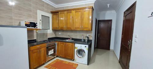 a kitchen with a washing machine and a washer at Doudy in Sharm El Sheikh
