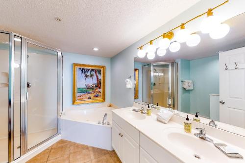 a bathroom with two sinks and a shower at Majestic Beach Resort Tower 2- 1805 in Panama City Beach