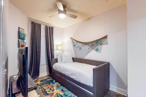a bedroom with a bed and a flat screen tv at Majestic Beach Resort Tower 2- 1805 in Panama City Beach