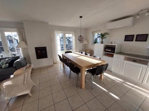 a kitchen and dining room with a table and chairs at Holiday home with spa, sauna and free access to indoor waterpark in Gjern