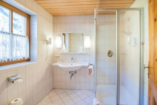 a bathroom with a sink and a shower at Hotel Winklerhof in Holzgau