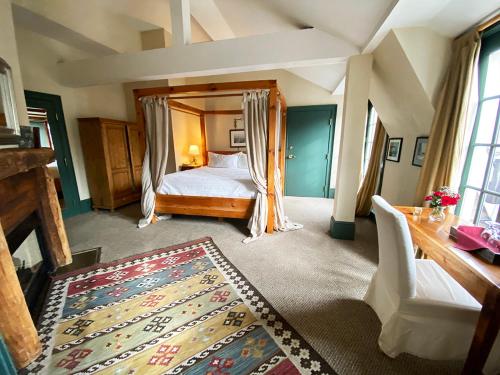 a bedroom with a large bed and a rug at The Red Lion Inn in Cohasset