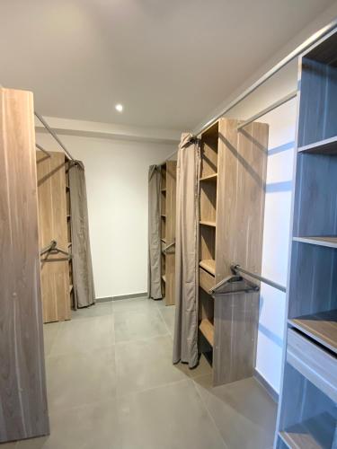 a walk in closet with wooden cabinets and shelves at La Listrella Residence & Spa in Monticello