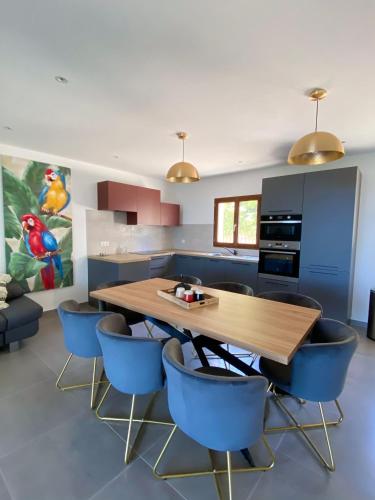 a kitchen with a wooden table and blue chairs at La Listrella Residence & Spa in Monticello