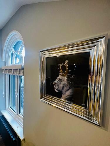 a picture of a head with a crown on a wall at 3 West End Boutique Apartment in Bowness-on-Windermere