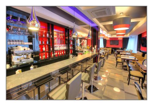 a restaurant with a bar with tables and chairs at Villa Park in Siedlce