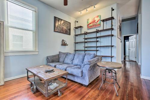 a living room with a couch and a table at 5 Mi to Bourbon Street Central NOLA Home in New Orleans