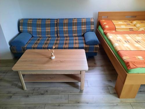 a living room with a couch and a coffee table at V přírodě na okraji Frenštátu pod Radhoštěm in Frenštát pod Radhoštěm