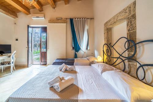 a bedroom with two beds with towels on them at Agriturismo Kypeiros in Noto