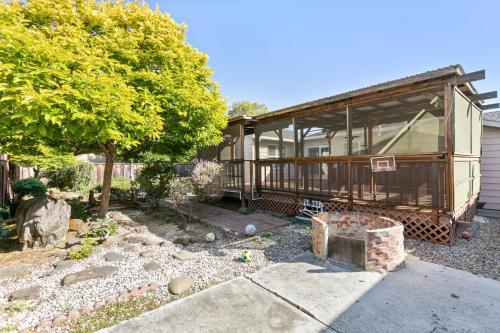 a house with a tree and a yard with a fireplace at @ Marbella Lane - Modern Refreshing Home in San Mateo