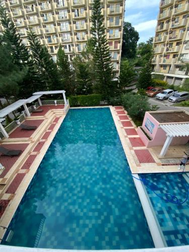 a large swimming pool in front of a building at Ness Haven Camella northpoint condominium in Davao City