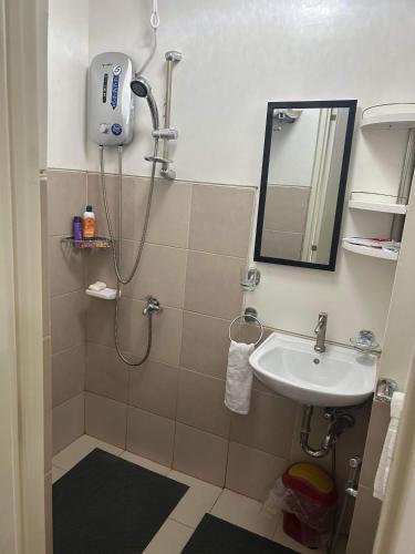 a bathroom with a shower and a sink at Ness Haven Camella northpoint condominium in Davao City
