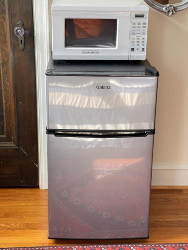 a microwave sitting on top of a refrigerator at Master Bedroom-Private Bath, Washington DC in Washington, D.C.