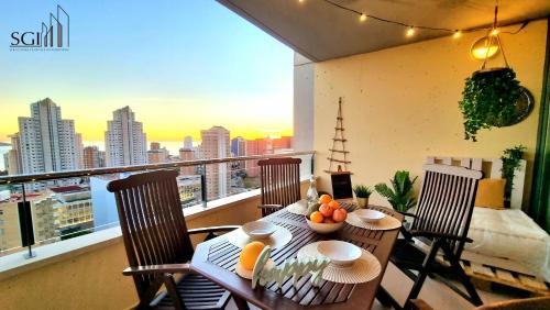a table and chairs on a balcony with a view of a city at SUNSET Chill Out- Torres D' Oboe in Benidorm
