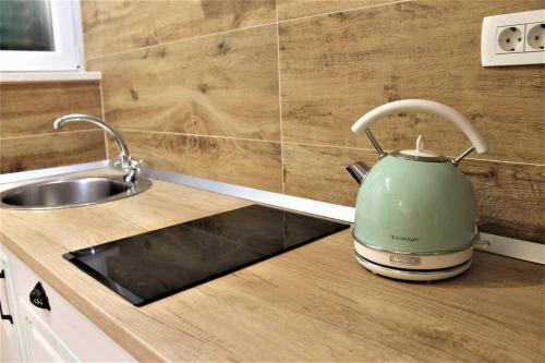 a green tea kettle sitting on a counter next to a sink at Apartment Barbara's Inheritance in Split
