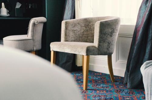two chairs sitting next to a window in a room at Gregory by the Warren Collection in Belfast