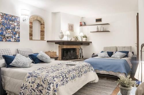 sala de estar con 2 camas y chimenea en Casa Porta Fontevecchia panoramica, en Spello
