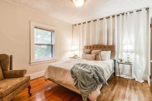 a bedroom with a bed and a chair and a window at NEWHOST-Victorian Pintrest Style 15min to Downtown in Detroit