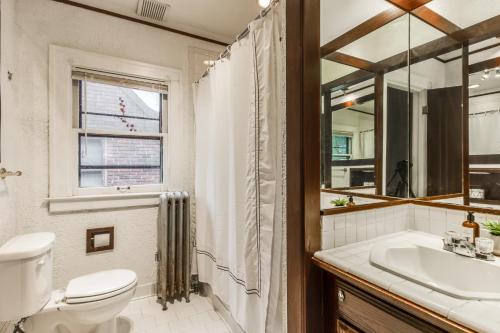 a bathroom with a toilet and a sink and a mirror at NEWHOST-Victorian Pintrest Style 15min to Downtown in Detroit