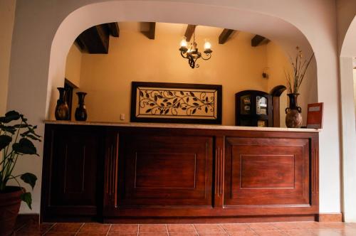 an archway in a room with a large wooden cabinet at Hotel Quinta Maya in Flores