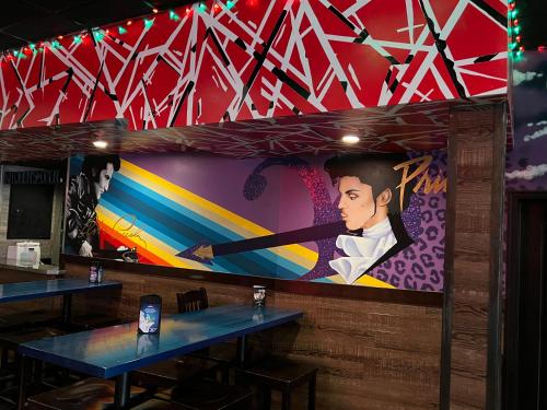 a large painting on the wall of a restaurant at Commercial Hotel in Edmonton
