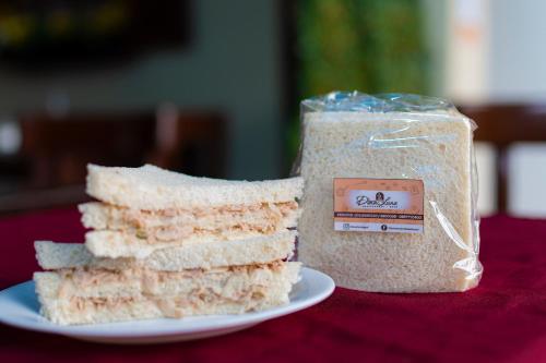 a piece of bread on a plate next to a container of food at Hotel de Alborada in Guayaquil