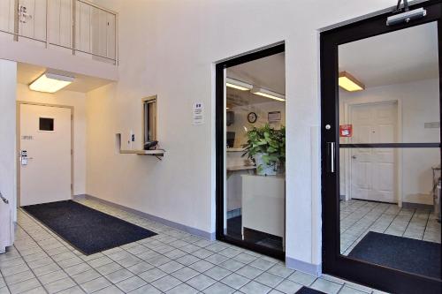 an empty hallway with a door in a building at Motel 6-Merrillville, IN in Merrillville