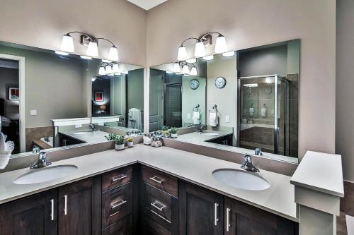 a bathroom with two sinks and two mirrors at Entrada at Moab 594 in Moab