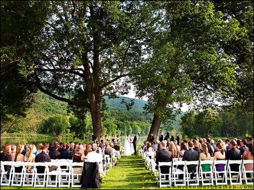 a bride and groom walking down the aisle at their wedding at Shawnee Inn and Golf Resort in East Stroudsburg