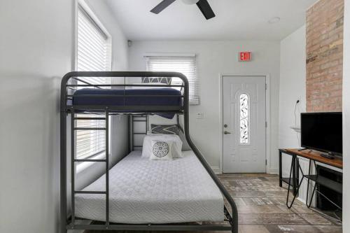a bunk bed in a room with a tv at Sleep 10 next to Superdome and downtown in New Orleans