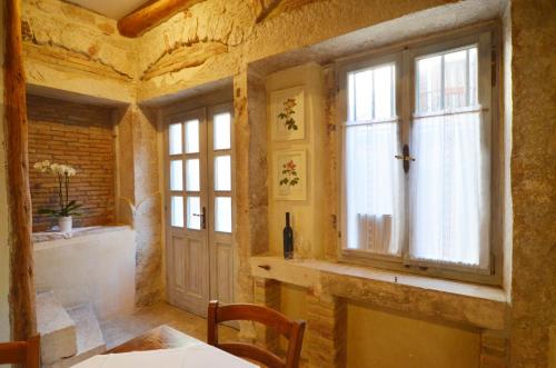 a dining room with a table and a window at House Trevisol in Rovinj