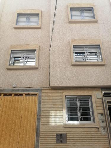 a building with three windows on the side of it at hay adrar 2 agadir Morocco in Agadir