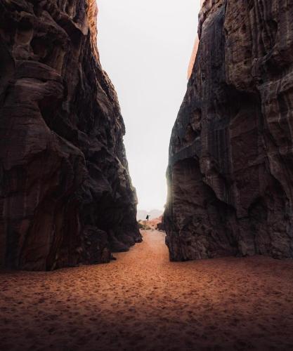 a narrow path between two large rocky cliffs at Wadirum Zeid camp&Tours in Wadi Rum