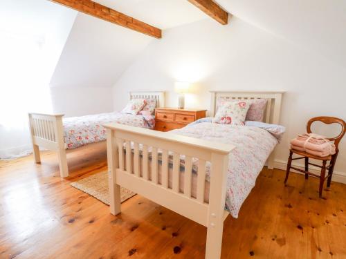 two twin beds in a bedroom with wooden floors at 20 Crown Street in Newark-on-Trent