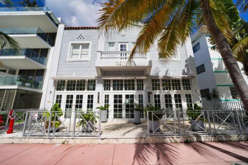 a white building with a palm tree in front of it at The Julia Hotel in Miami Beach