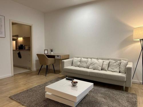 a living room with a couch and a table at MORINA Residences in Mainz