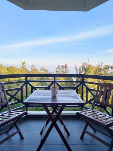 a table and two chairs on a balcony at Fraser Hill Silverpart Resort A3-1-1 Forest View With Lift in Bukit Fraser
