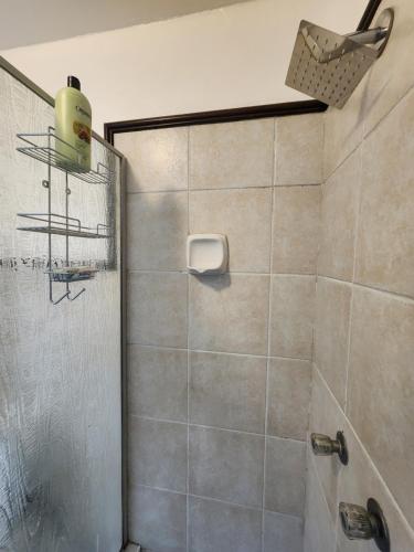a bathroom with a shower with a glass door at 2a - 64 No load shedding 2bed 2bath with garden in Centurion