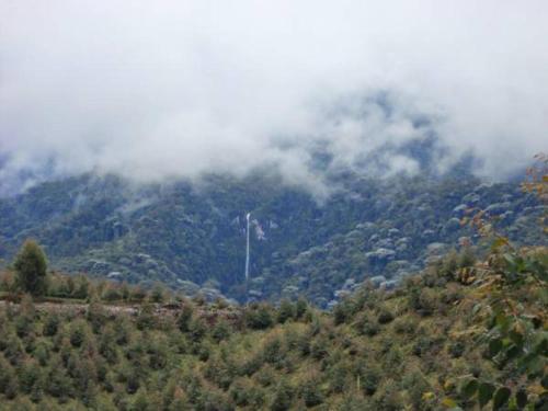 a view of a mountain with clouds on it at Hotel Bariloche in Santa Rosa de Cabal