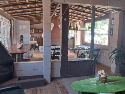 a large room with a table and a room with a table sidx sidx at Pousada Beija flor in Extrema