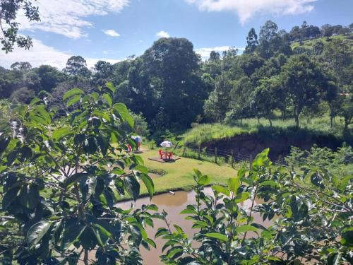 a view of a river with trees in the background at Pousada Beija flor in Extrema