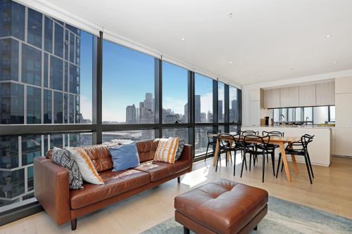 a living room with a couch and a table at Orange Stay Apartments in Melbourne