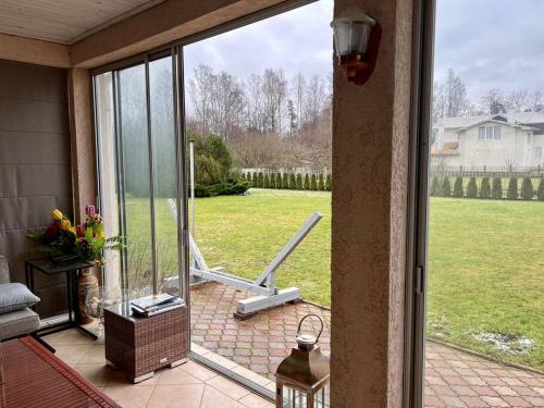 an open door to a patio with a view of a yard at Friendly House in Jurmala in Jūrmala