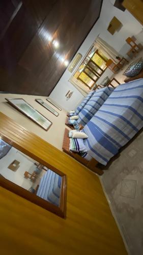 a view of a bedroom with a bed and a mirror at Poseidon Guest House in Iquitos