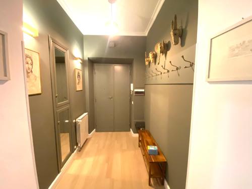 a hallway with a wooden floor and a room with a door at SWEETSUITE Rome in Rome