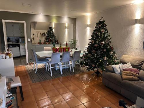 een woonkamer met een kerstboom en een tafel en stoelen bij Coliving Vila Mariana in Sao Paulo