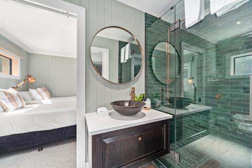 a bathroom with a sink and a glass shower at Stagford Retreat Apartment - Taupo in Taupo